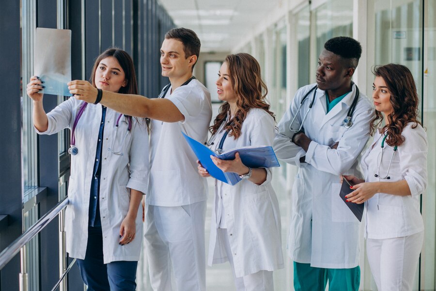 team-young-specialist-doctors-standing-corridor-hospital_1303-21198